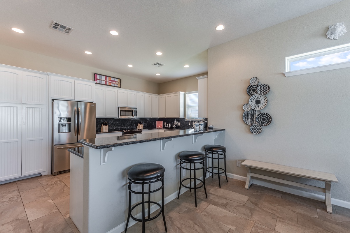 Your open kitchen features modern appliances and a breakfast bar where you can sip coffee while planning the day's adventures.