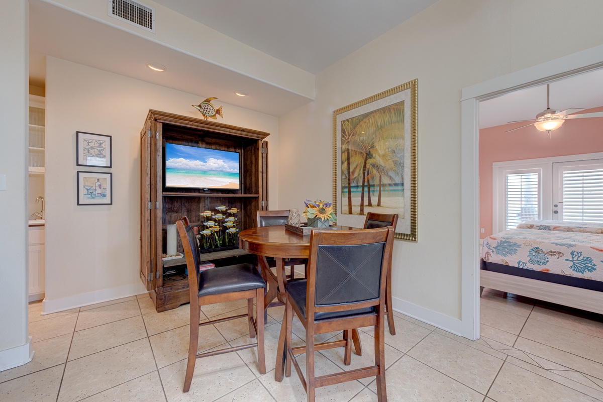 Gather around your cozy dining table for meals while tropical art and entertainment create the perfect vacation atmosphere.