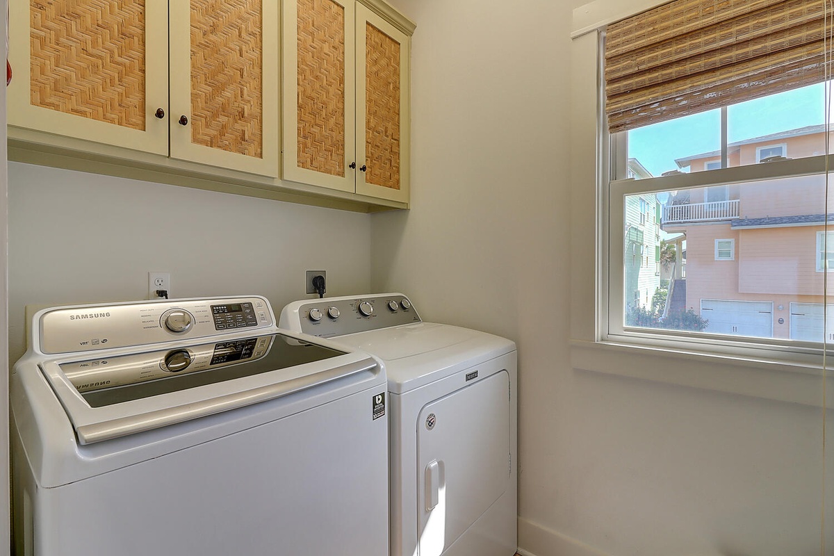 Your dedicated laundry room keeps your vacation wardrobe fresh with full-size washer and dryer, plus stylish storage above.