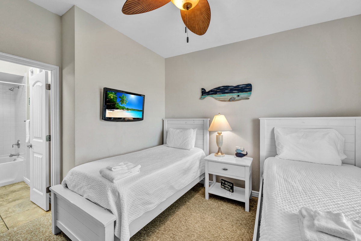 Rest comfortably in your twin bedroom with crisp linens, coastal decor, and entertainment at your fingertips.