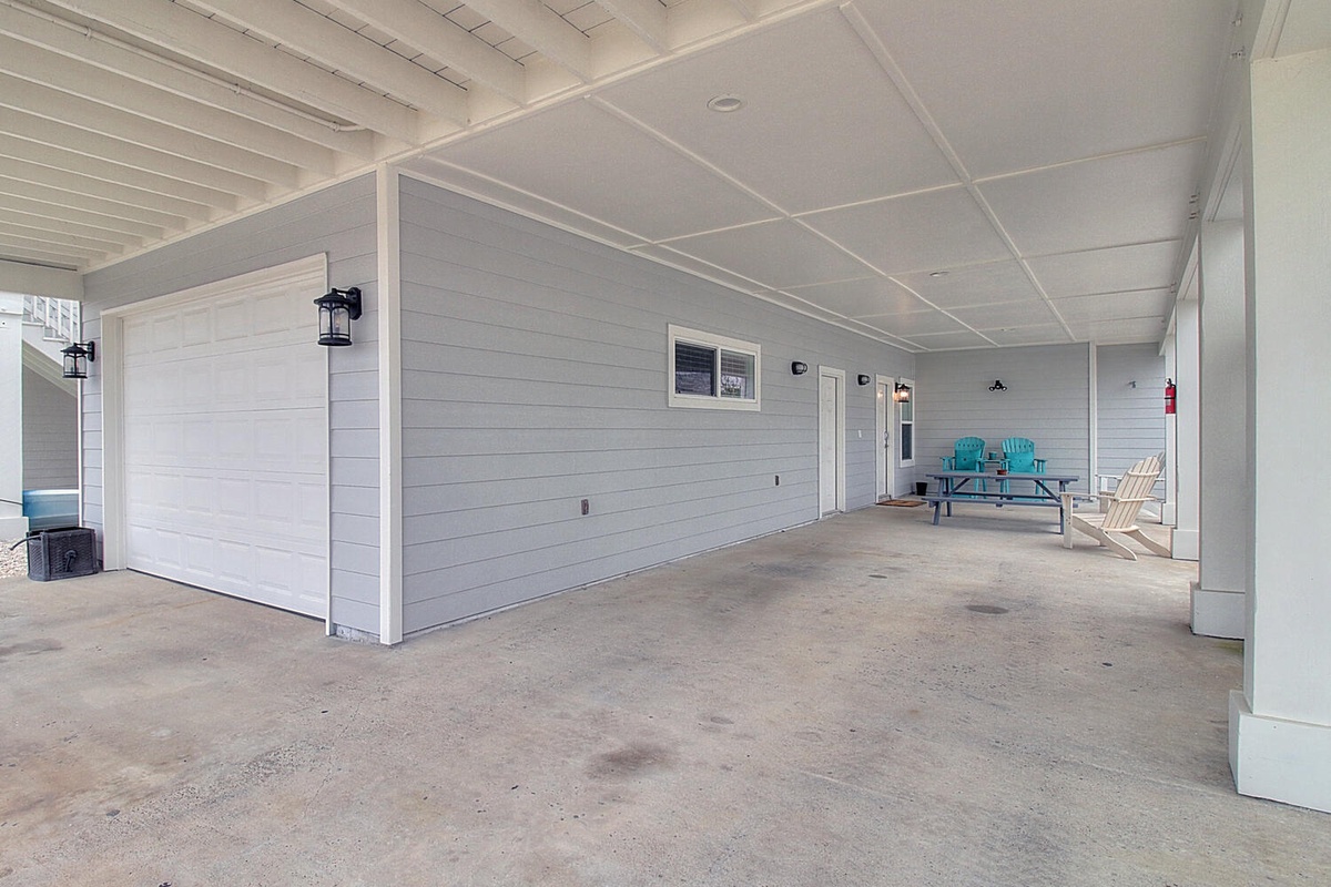 Spacious covered area with seating and storage - perfect for relaxing after beach days or storing your gear.