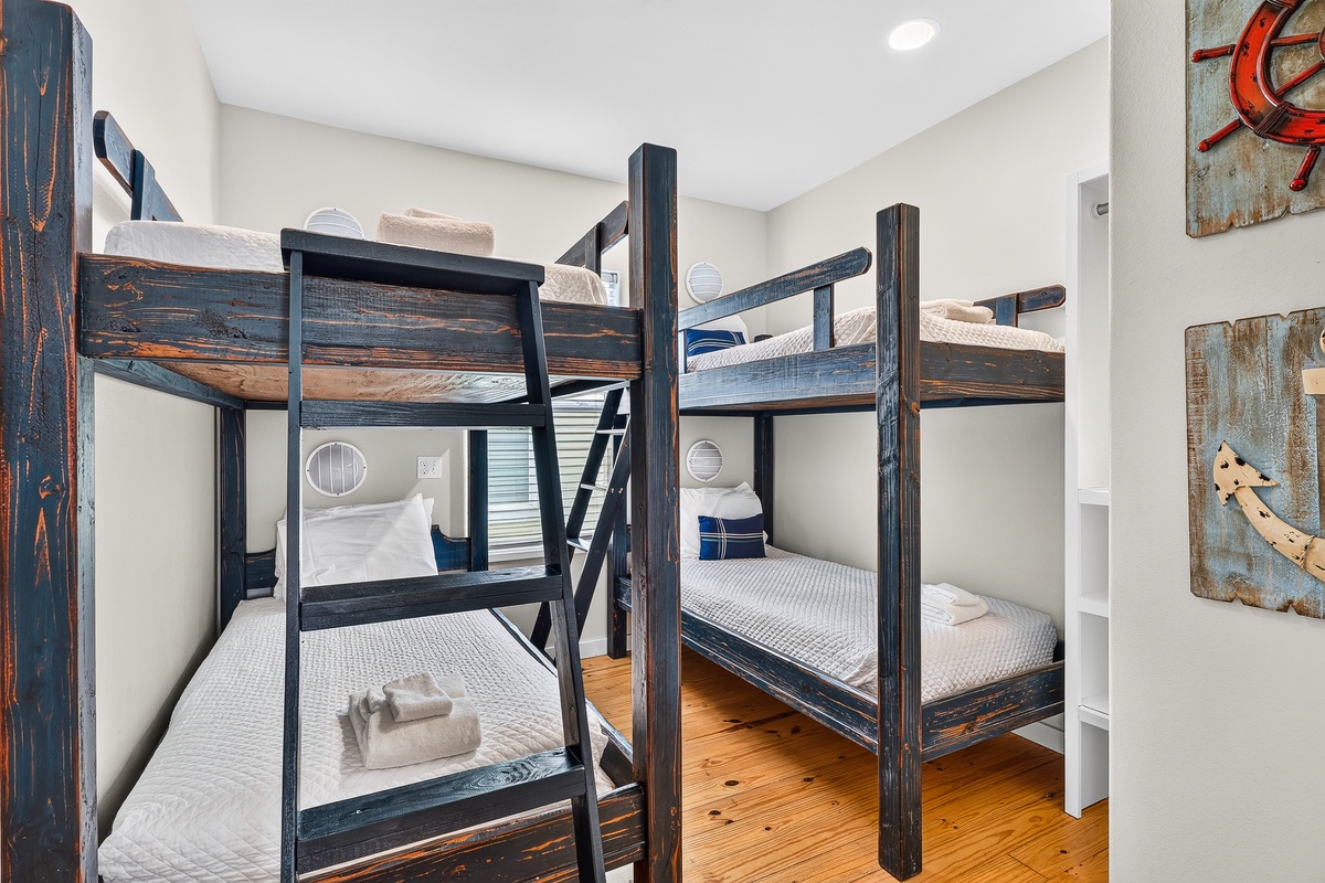Perfect for families or groups, this cozy bunk room features sturdy custom-built beds with crisp white linens and warm wooden floors. Each bed has its own window for natural light and fresh mountain air.