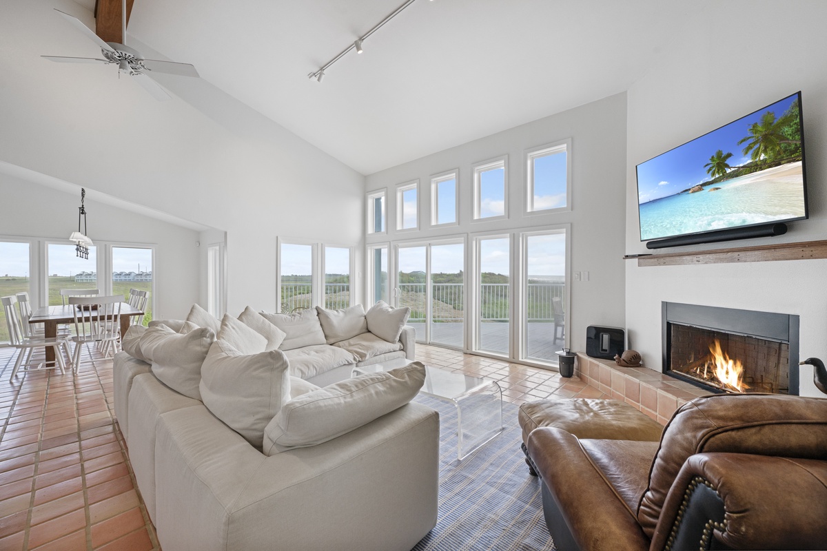 Sink into plush sofas by your crackling fireplace while panoramic windows frame stunning views across the landscape.