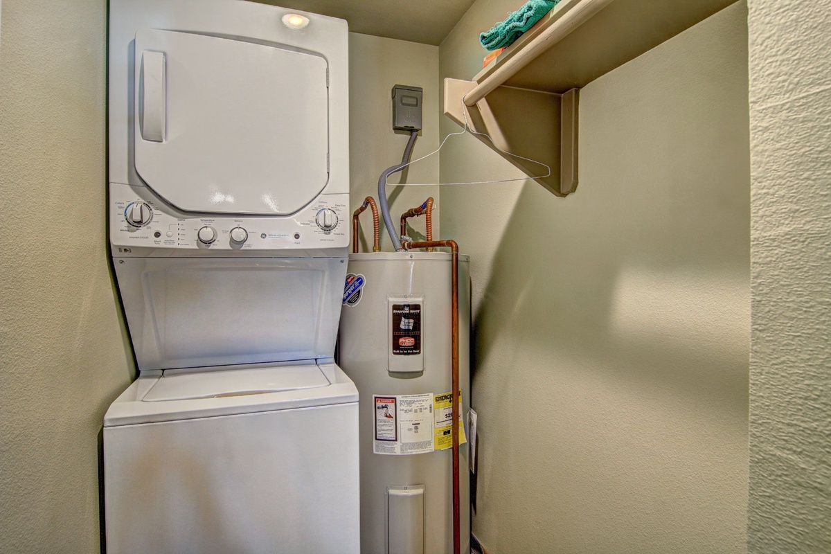 Your private laundry room keeps you organized with stacked washer-dryer, water heater, and handy storage shelving for all your vacation necessities.
