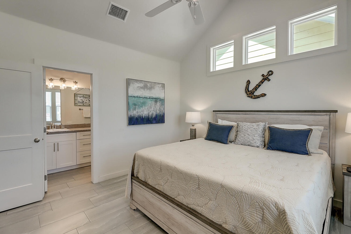 Your coastal-themed bedroom awaits with plush bedding and nautical charm, complete with private bathroom access.