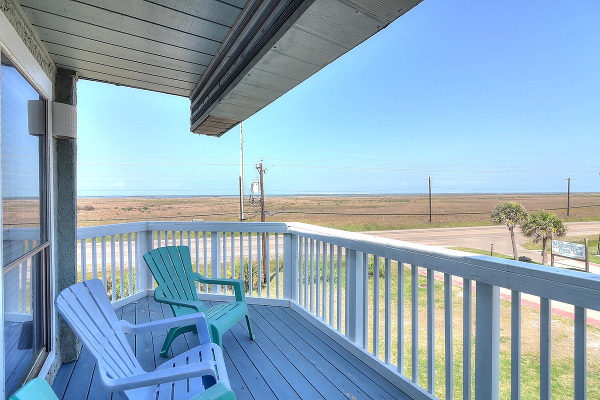 Your private balcony offers comfortable seating and sweeping coastal views where you can unwind while watching the endless horizon.