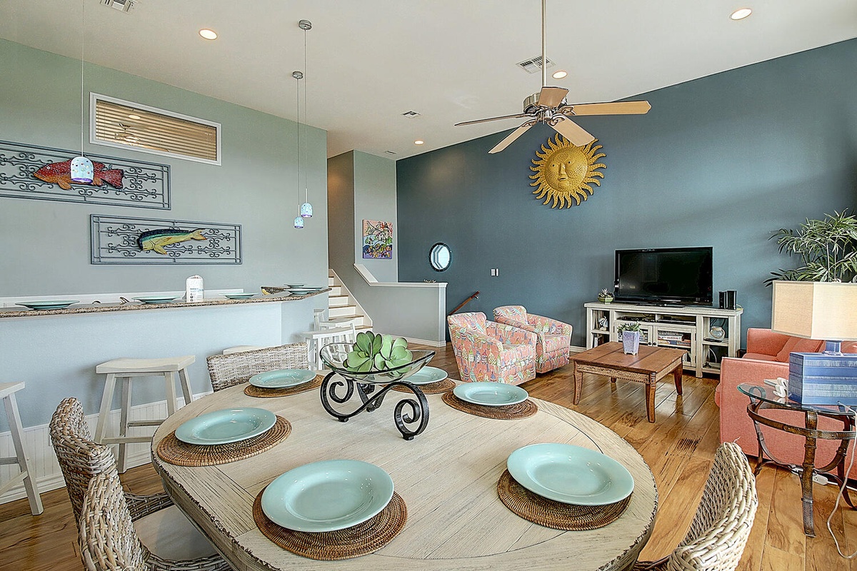 Gather around this beautiful dining table where coastal charm meets comfort. The open layout flows into your cozy living space.