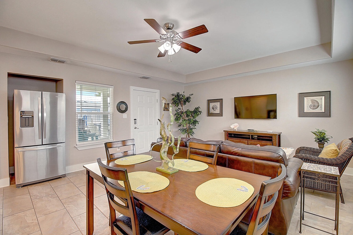 Gather around this inviting dining table for memorable meals, with your cozy living area just steps away for post-dinner relaxation.