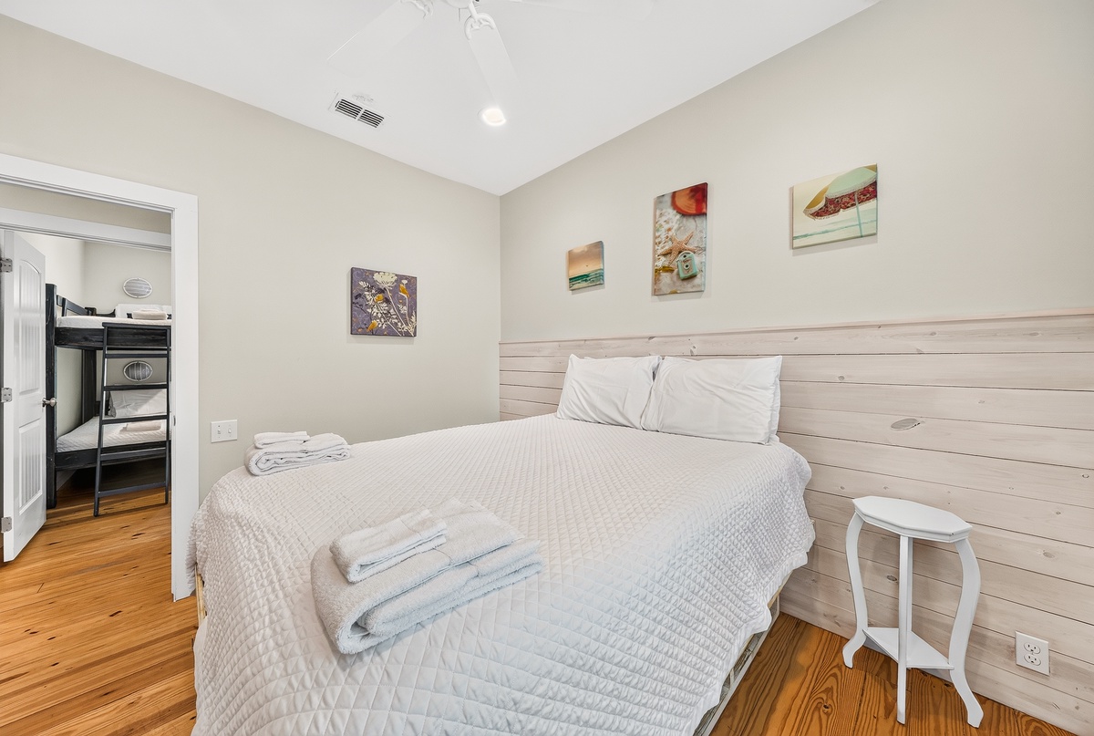 Drift off to sleep in your inviting bedroom, where soft linens and a soothing coastal-inspired palette wrap you in comfort after a day of adventure.