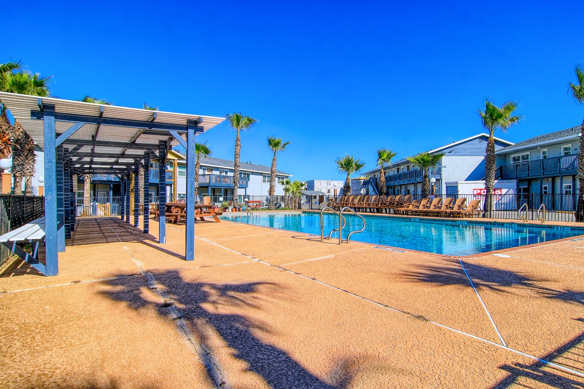 Dive into your tropical oasis! This sparkling pool beckons with crystal-clear waters, poolside loungers, and swaying palms creating your perfect sunny retreat.