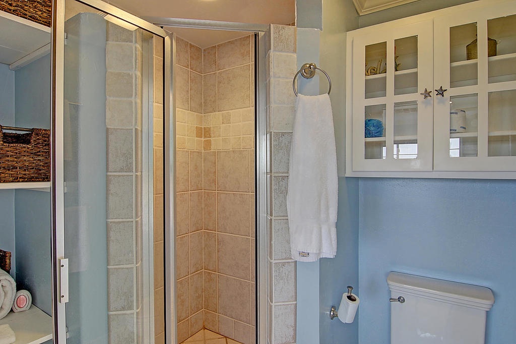 Step into your private sanctuary with a spacious tiled shower, plush towels, and thoughtful storage throughout.