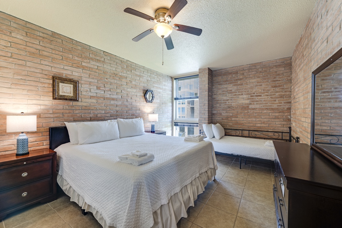 Unwind in this inviting bedroom featuring a king bed, twin daybed, and fresh linens for a restful night's sleep.