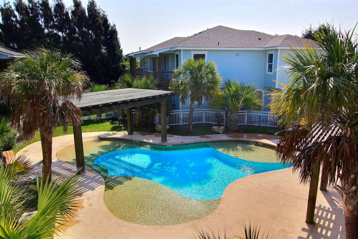 Tropical paradise awaits with your private pool oasis surrounded by swaying palms and coastal charm.