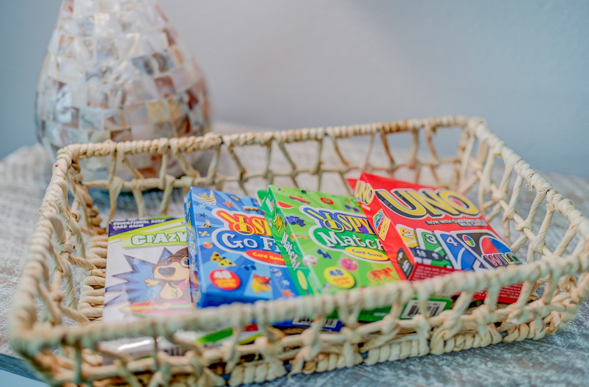 Discover a thoughtful selection of games waiting in your cozy wicker basket, perfect for memorable family evenings together.