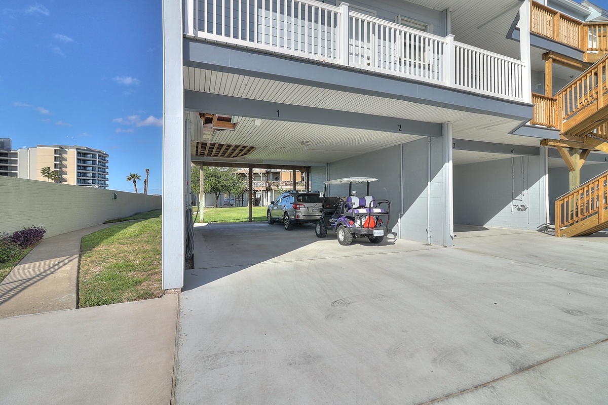 Covered parking protects your vehicle while a golf cart awaits your coastal adventures in this beachside neighborhood.
