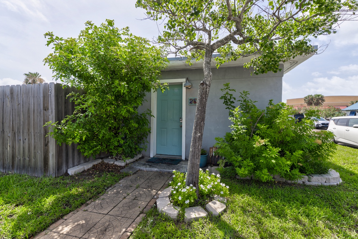 A warm welcome awaits at this charming coastal retreat, where lush landscaping and a private entrance set the tone for a relaxing stay.