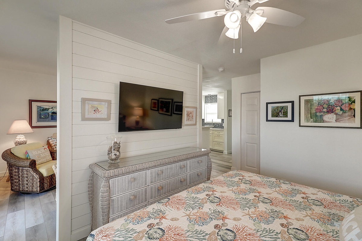 Your cozy bedroom features a comfy bed, flat-screen TV, and gentle ceiling fan for peaceful nights.