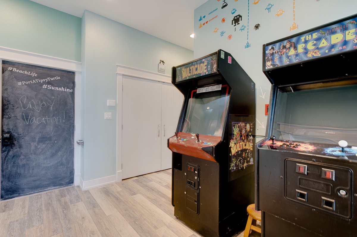 Your own arcade room with classic games and a welcoming chalkboard message sets the perfect tone for vacation fun.