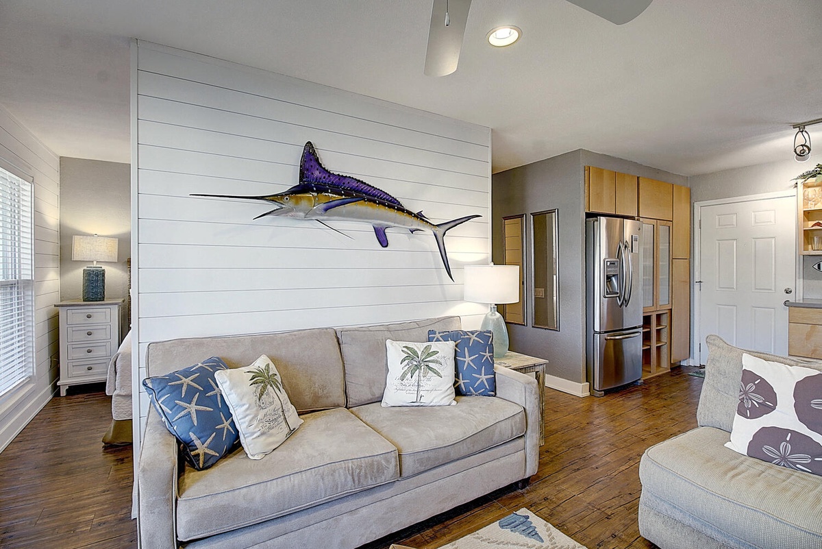 Settle into your coastal-themed living space where nautical charm meets modern comfort, complete with a striking marlin centerpiece.