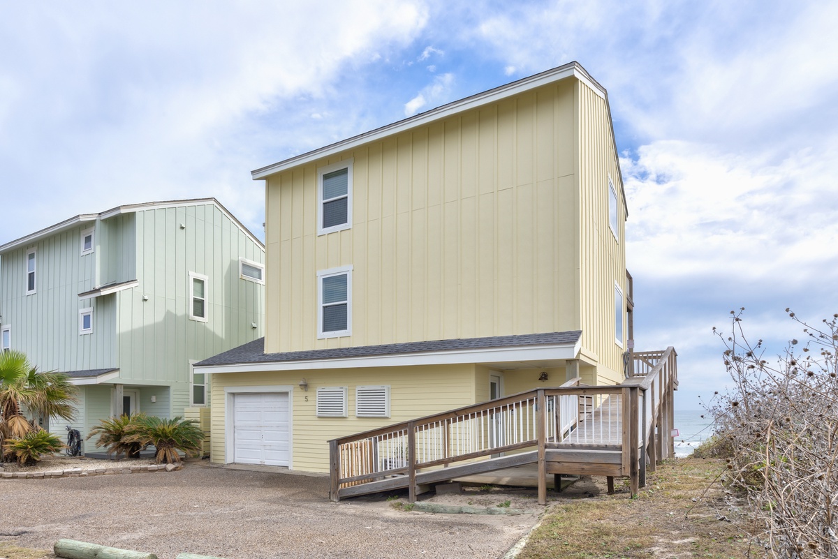 Charming beachside retreat with modern coastal architecture and private garage for convenient arrival.