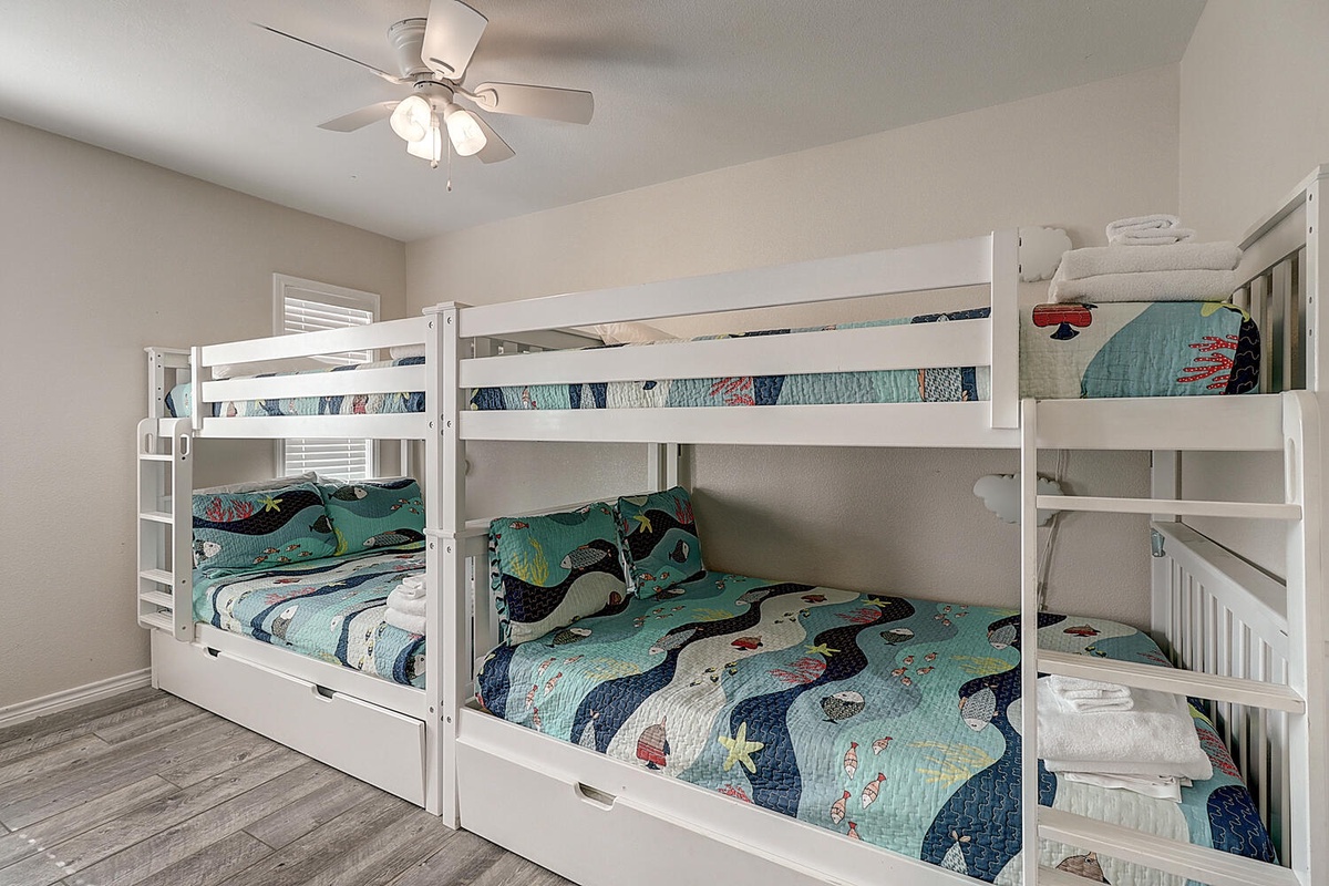 Your kids will love this cheerful bunk room with ocean-themed bedding and plenty of space for adventure stories.