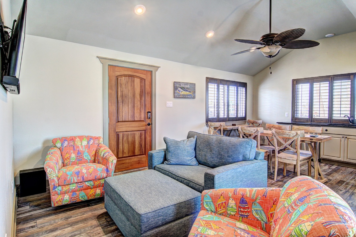Relax in your bright, colorful living space with tropical-print seating, modern amenities, and a cozy dining area perfect for vacation memories.