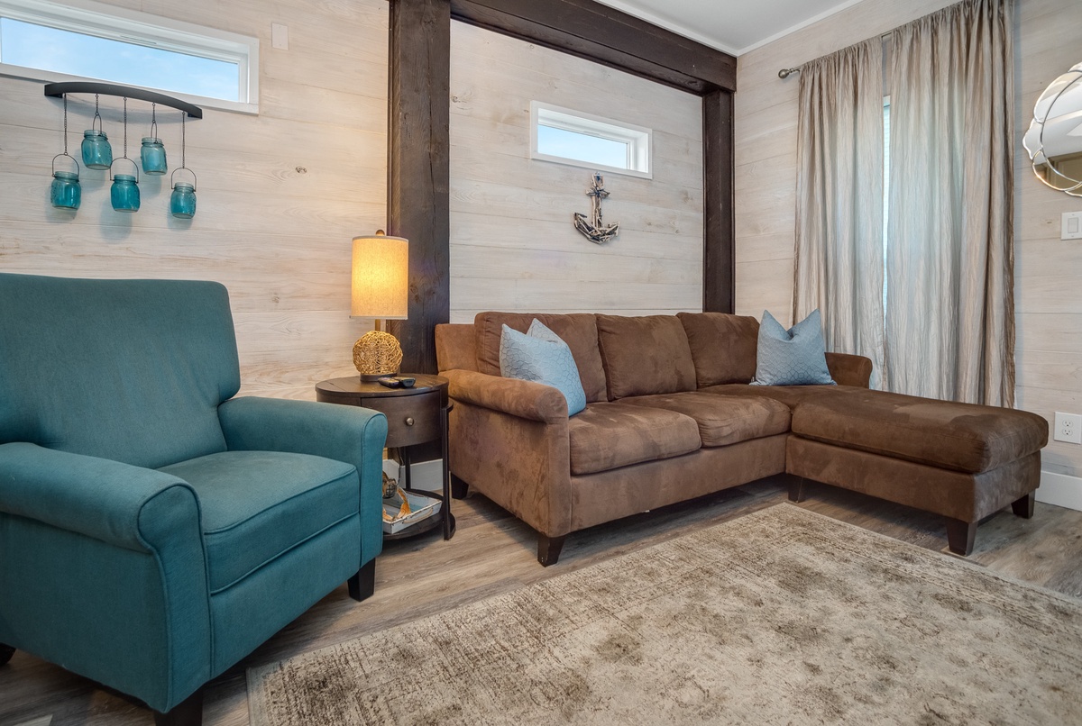 Sink into your cozy coastal living room with nautical touches, soft lighting, and comfortable seating perfect for relaxing evenings.