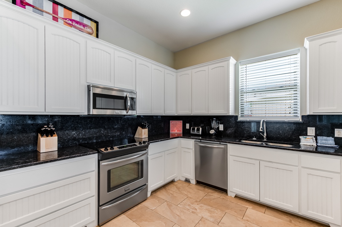Cook your favorite meals in this sleek kitchen with granite countertops, stainless steel appliances, and plenty of cabinet space for all your needs.