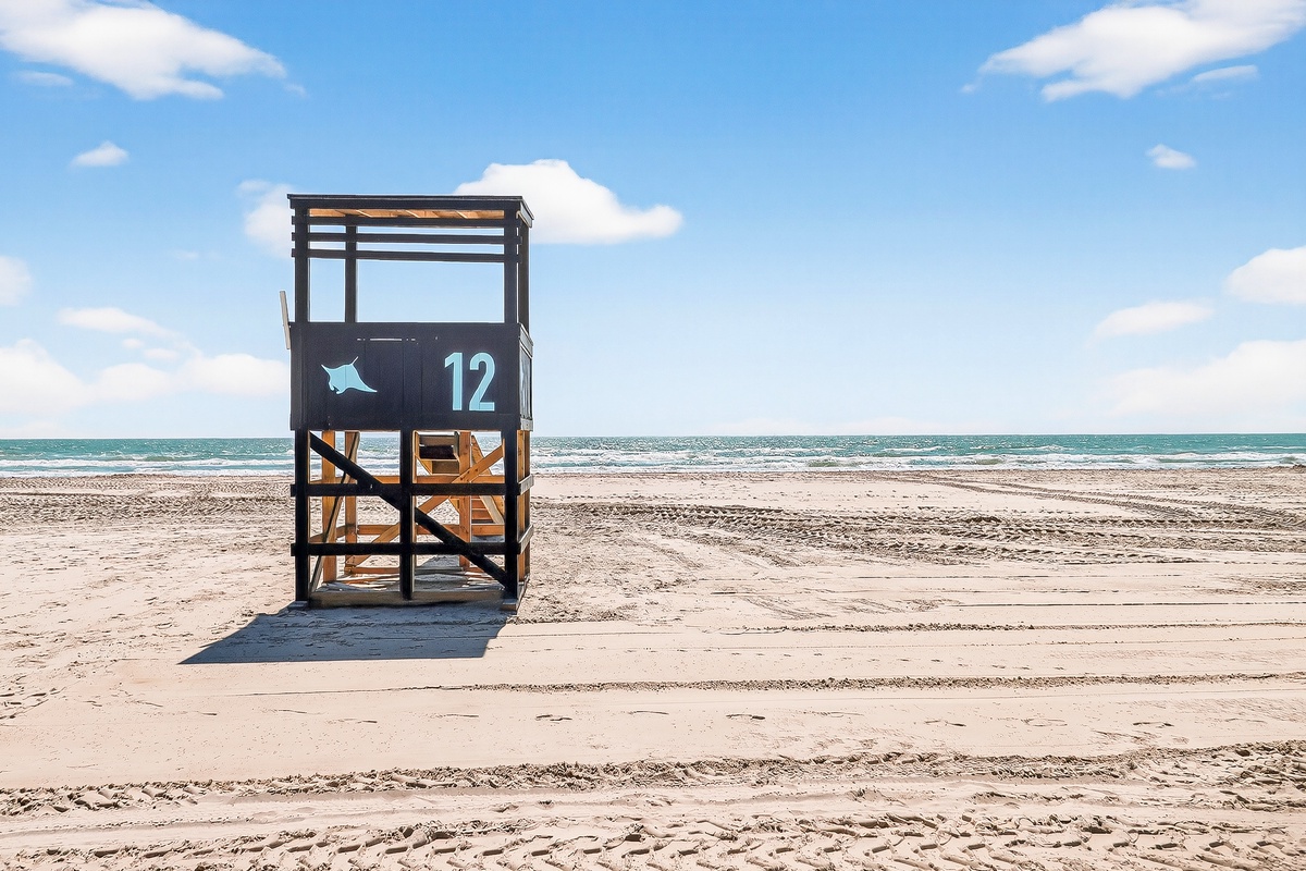 A pristine beach setting with soft sand and endless ocean views, perfect for peaceful seaside getaways.