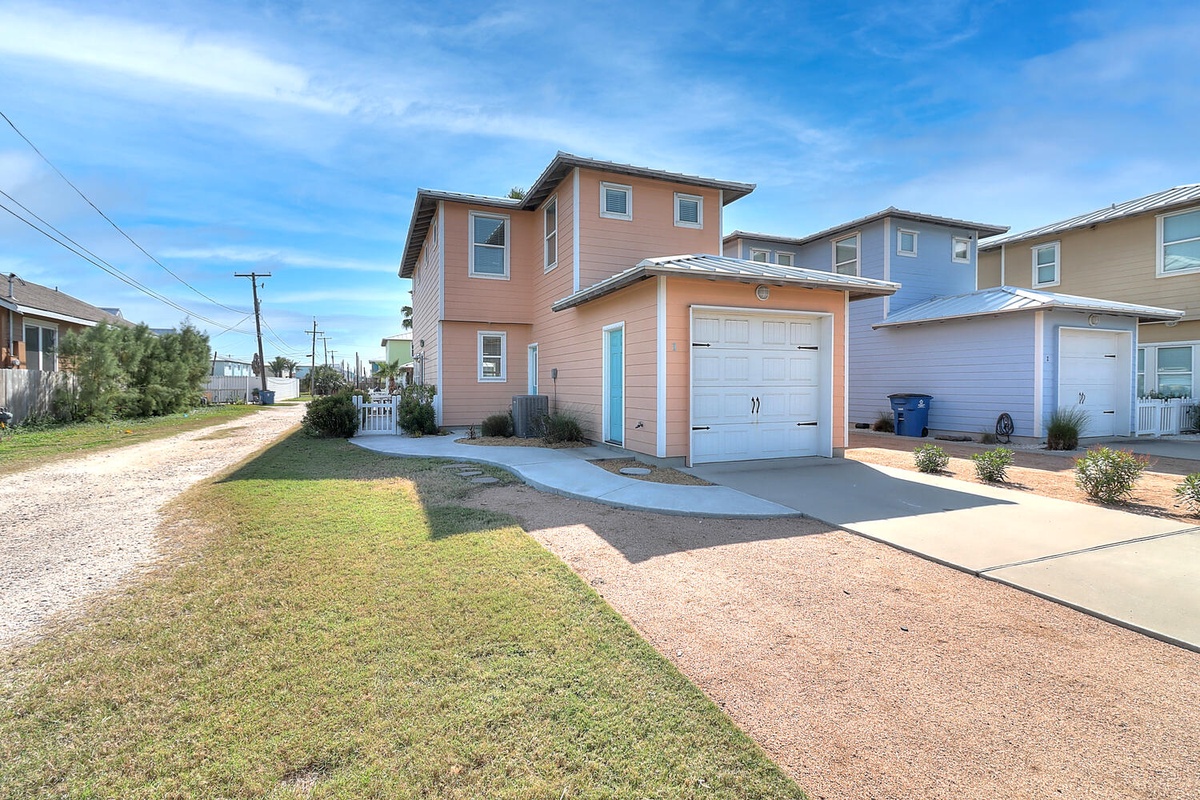 Modern two-story home with garage parking in a peaceful residential neighborhood, featuring a well-maintained yard and convenient driveway access.
