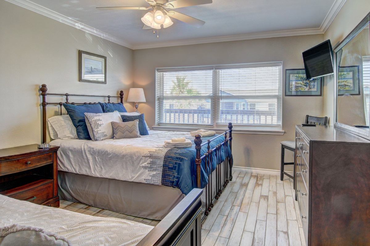 Drift off in your cozy bedroom with plush bedding, gentle ceiling fan, and relaxing blue accents.