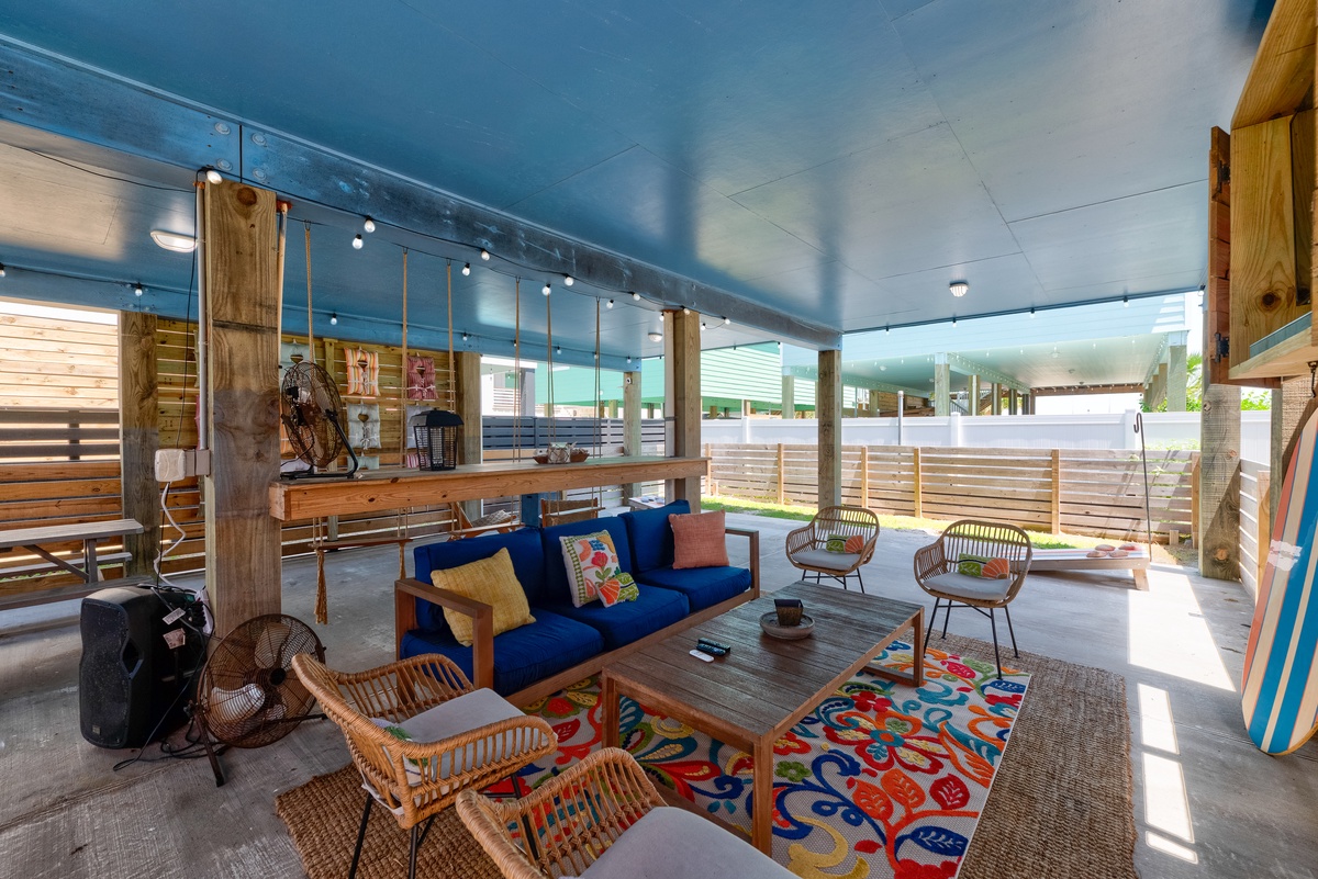 Unwind in your breezy open-air lounge, where vibrant colors and coastal charm invite you to relax and soak up island vibes.