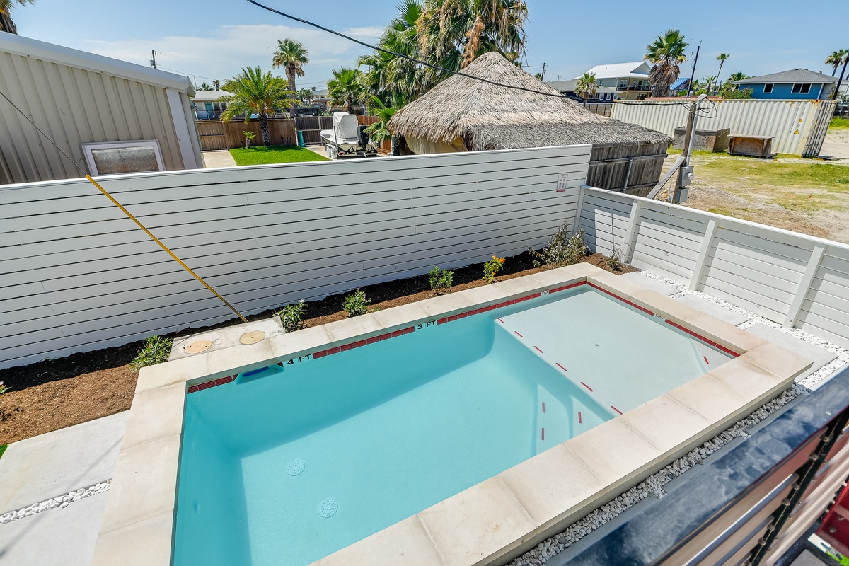 Your private pool and spa await in a tropical setting with palm trees and modern design.