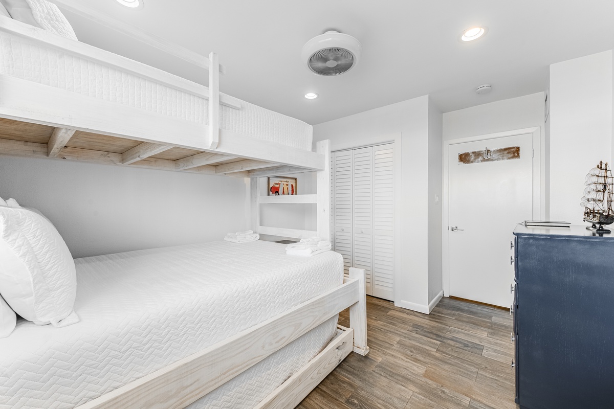 Your cozy bunk room features crisp white linens and coastal charm, perfect for family adventures with built-in storage and nautical touches.