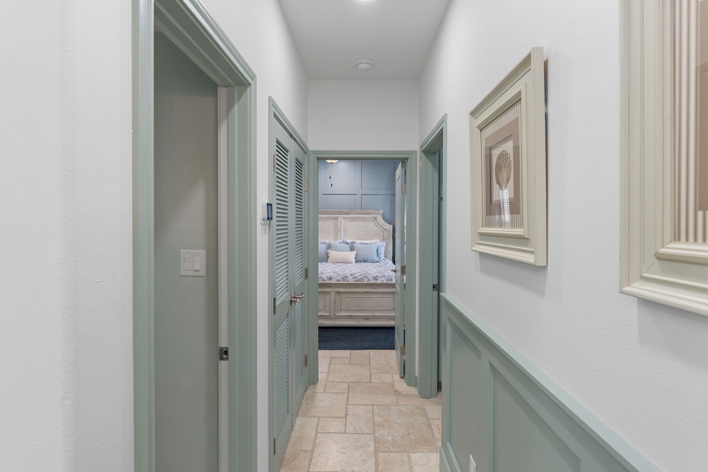 Your private hallway leads to peaceful bedrooms with soothing sage-green accents and elegant coastal charm.