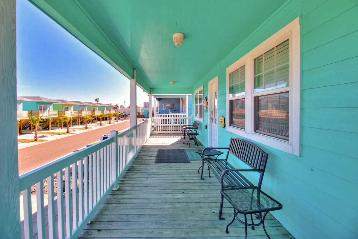 Relax on your private covered balcony with outdoor seating, enjoying gentle ocean breezes and colorful coastal views.