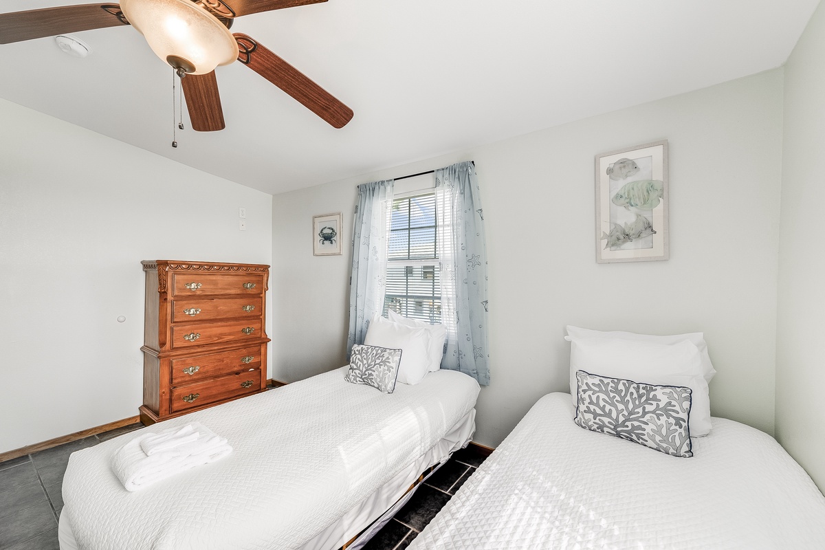 Rest peacefully in your comfortable twin beds under charming exposed beams, with gentle natural light and coastal-inspired decor.