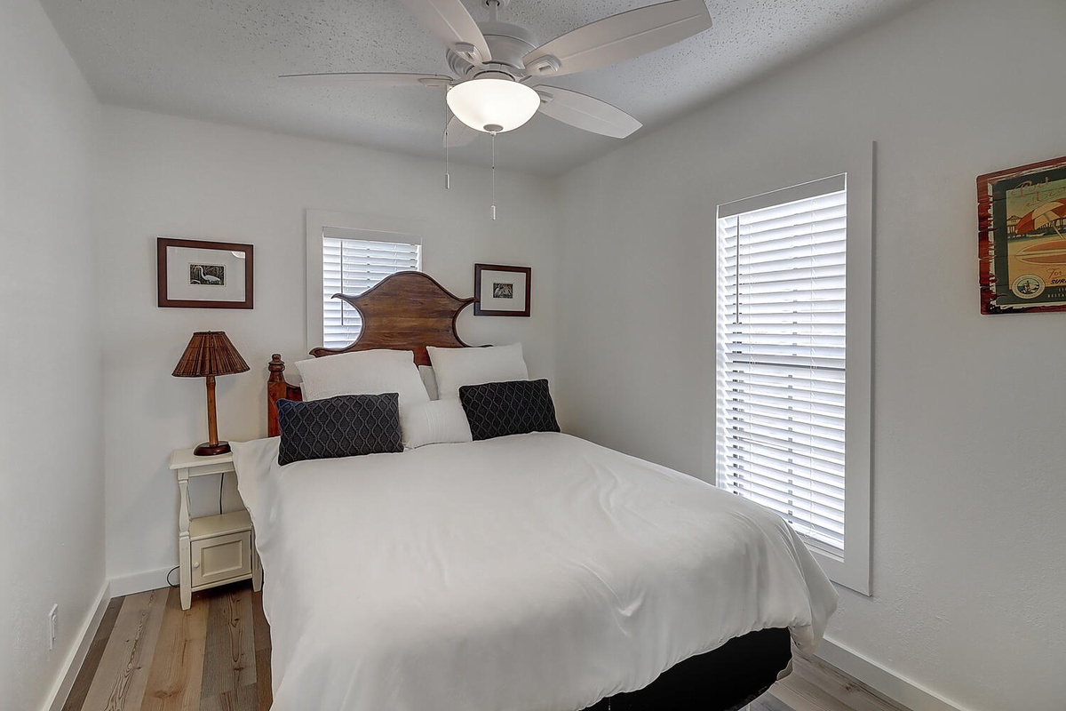 Drift off peacefully in your cozy bedroom with its plush bedding, gentle ceiling fan, and warm natural light.