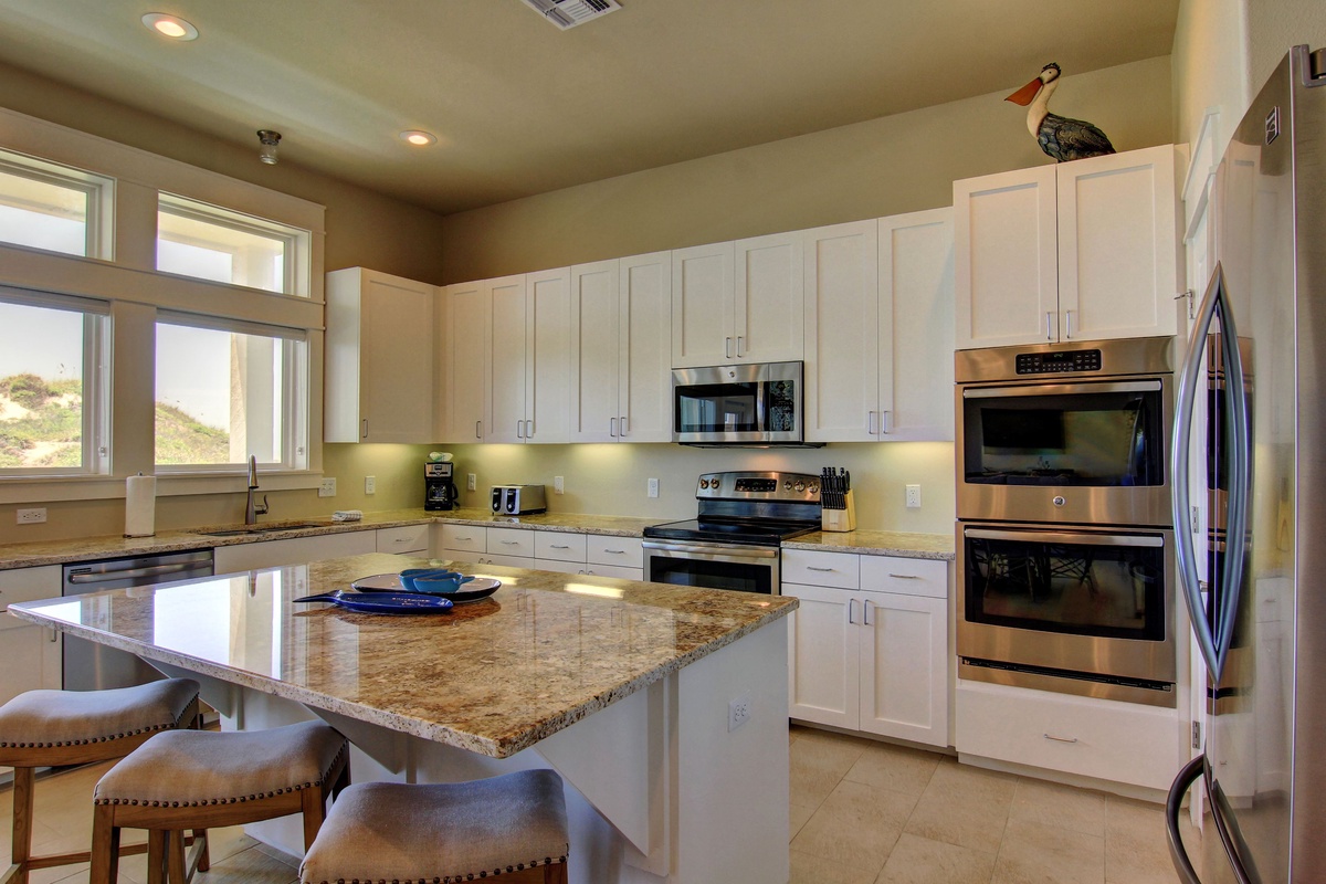 Your fully equipped kitchen features granite counters, stainless appliances, and breakfast bar seating for easy meal prep and casual dining.