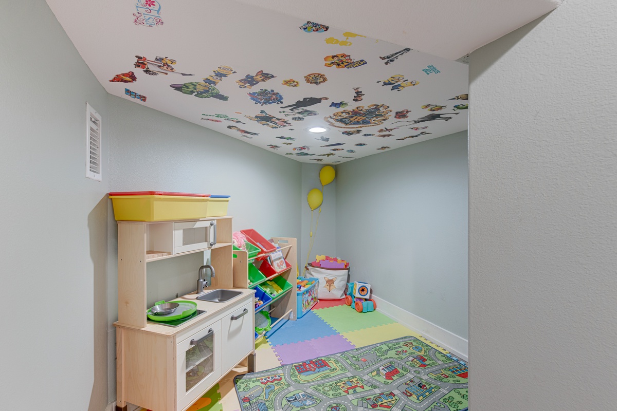 Your little ones will love this whimsical play space with toy kitchen, colorful ceiling decals, and soft play mats for endless entertainment.