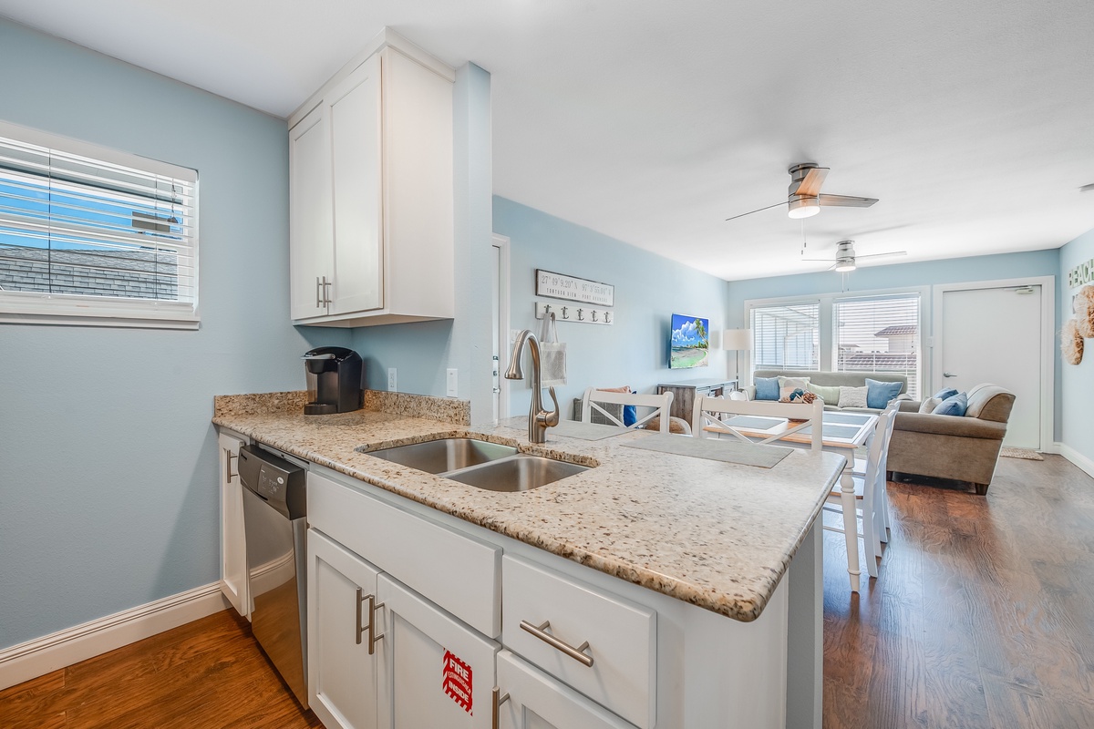 Your open-concept kitchen flows seamlessly into the living area, perfect for cooking and socializing with granite counters and modern appliances.