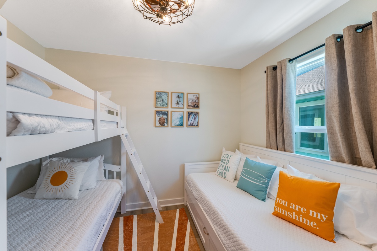 Your sunny bedroom features cozy bunk beds with cheerful pillows, perfect for family adventures and restful nights together.