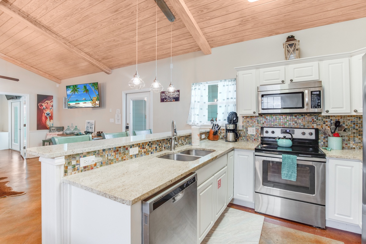 Your bright, fully-equipped kitchen welcomes you with granite counters, colorful tile backsplash, and vaulted wood ceilings for memorable meal prep.