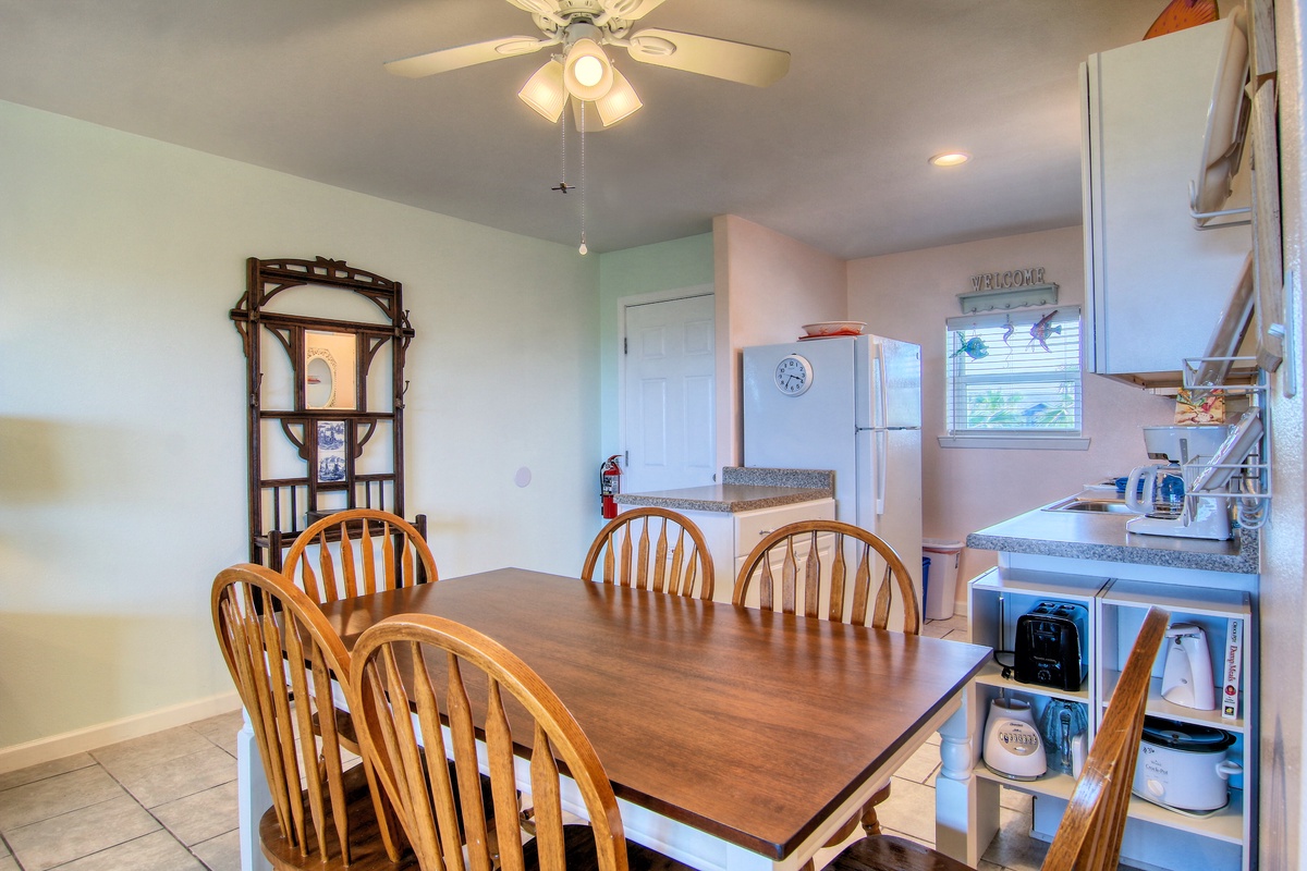 Gather your family around this welcoming dining table for memorable meals together, with a fully equipped kitchen ready for your culinary adventures.