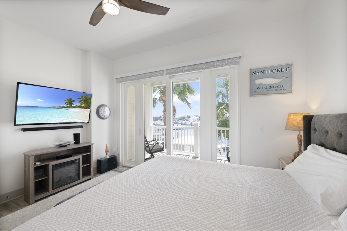 Drift off to sleep watching tropical scenes on your wall-mounted TV, then wake to marina views from your private balcony.