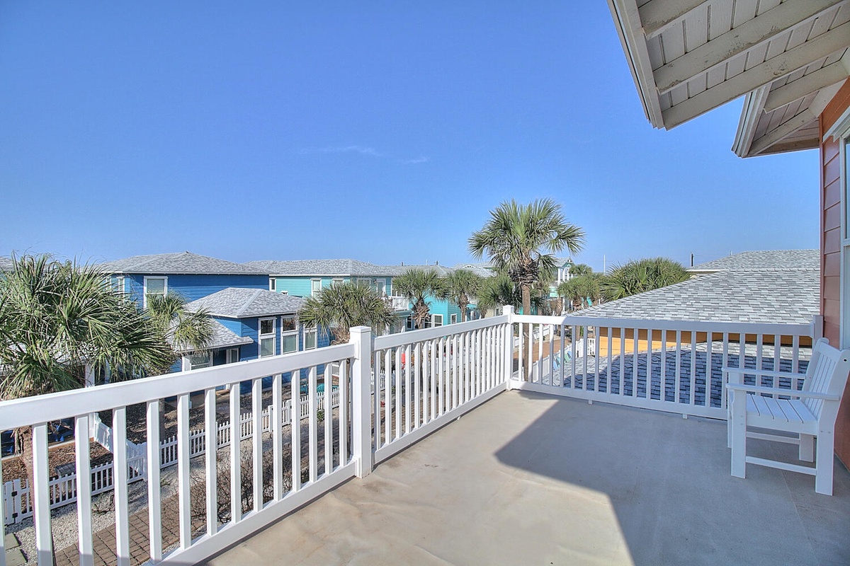 Step onto your private balcony and soak in panoramic views of colorful beach homes and swaying palms under endless blue skies.
