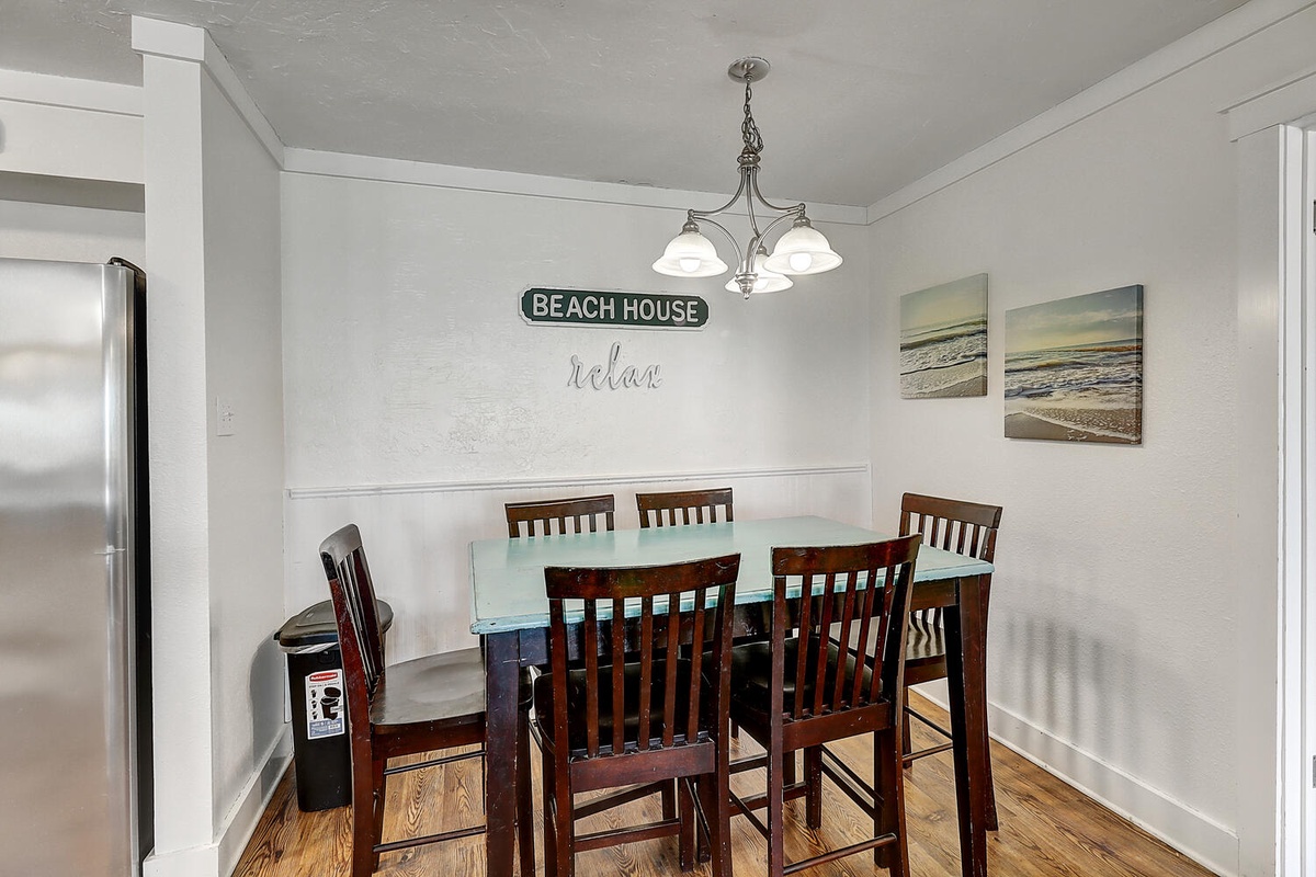 Gather around this inviting dining table where you'll share memorable meals in your beach house retreat.