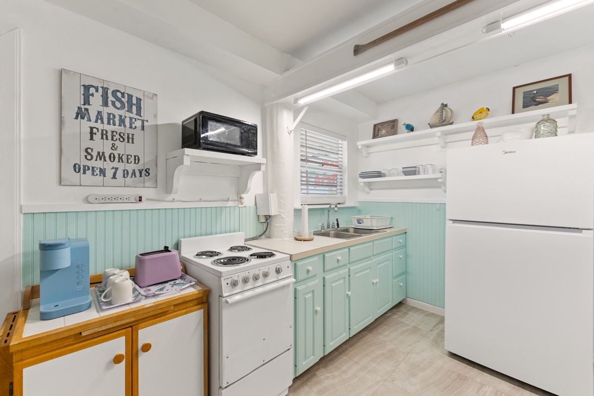 Cook your favorite meals in this charming coastal kitchen with vintage touches and all the essentials you need.