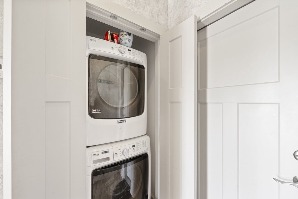 Keep your clothes fresh with your own private washer and dryer, neatly tucked away in this convenient laundry closet.