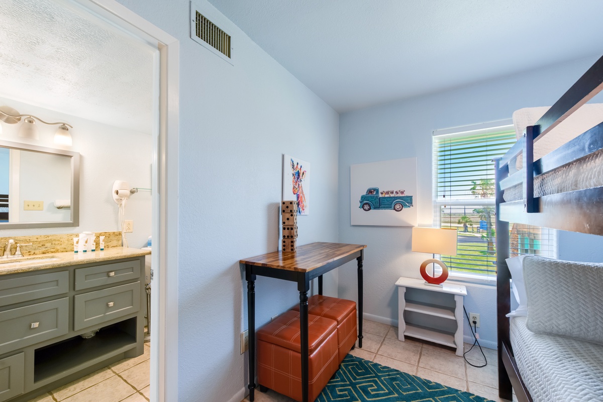 Your kids will love this playful bedroom with bunk beds and cheerful artwork, while you appreciate the adjacent bathroom.